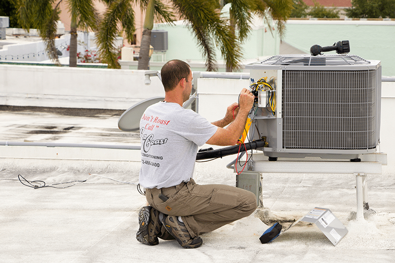 A SeaCoast Technician doing AC repairs